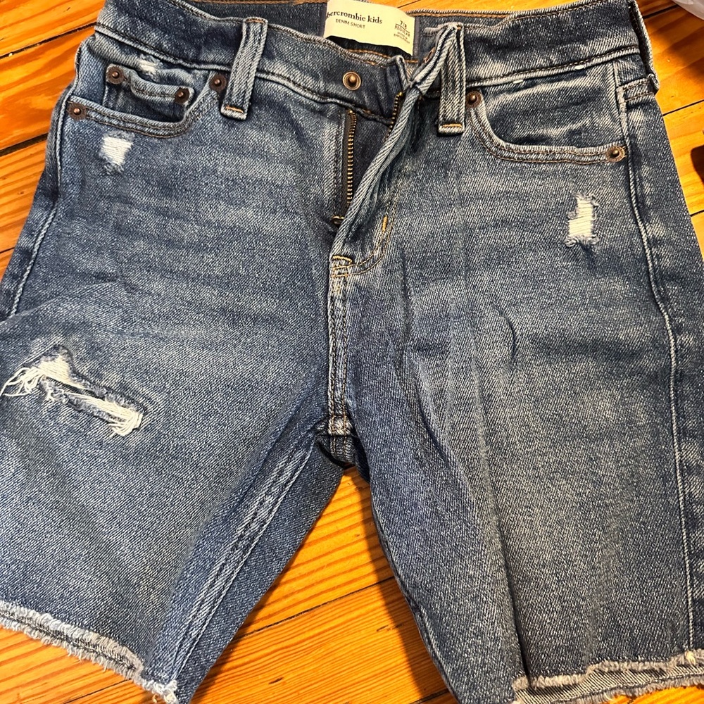 Our new at-the-knee length denim shorts, featuring a blue wash,